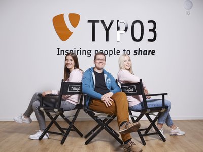 toujou's service team sitting in front of the TYPO3 logo